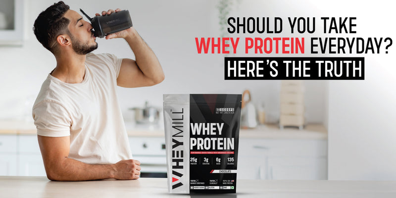 Man drinking whey protein shake with whey protein pack on kitchen counter – daily whey protein intake explained