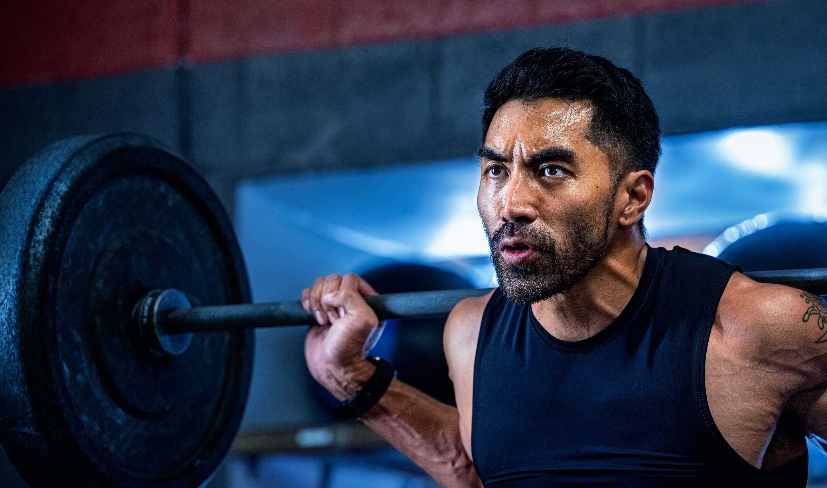 A woman jogging in front of a wall.